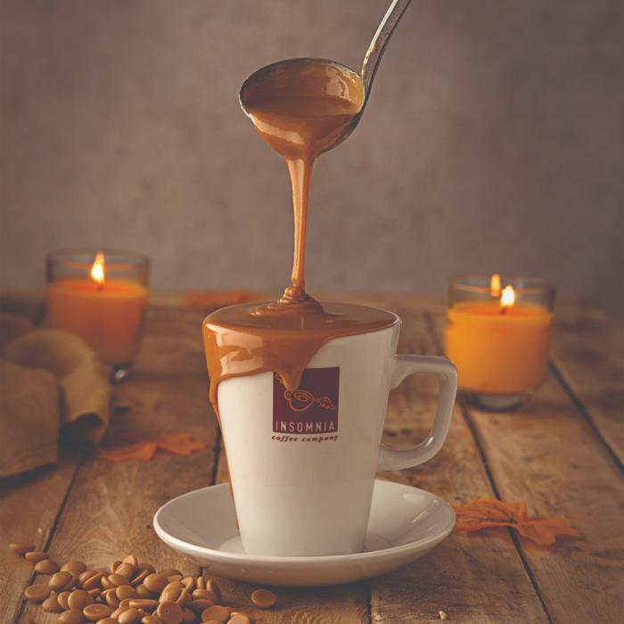 Ladle of caramel flowing into a coffee cup