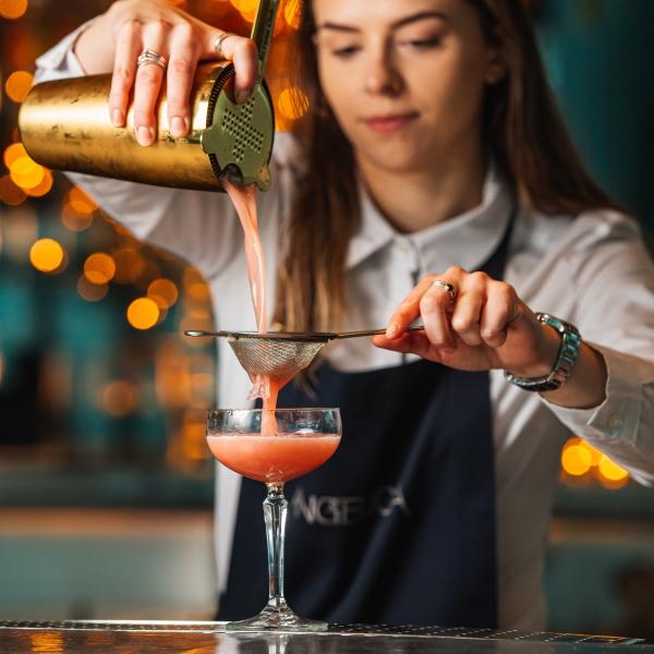 Waitress pouring pink martini